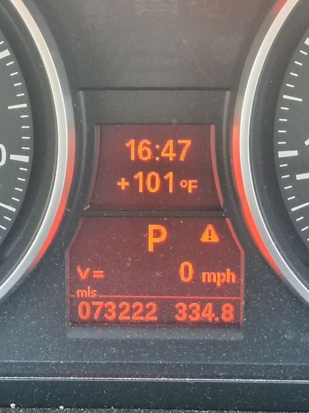 The car dashboard displays the time as 16:47, temperature at +101°F, parked gear (P), speed at 0 mph, odometer reading 073222 miles, and 334.8 on a secondary metric, all illuminated in orange and red against a black background.